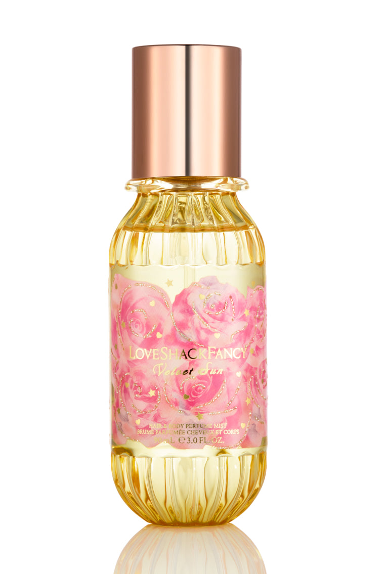 Mini hair and body mist bottle with rose-gold cap, gold ribbed glass, pink floral label