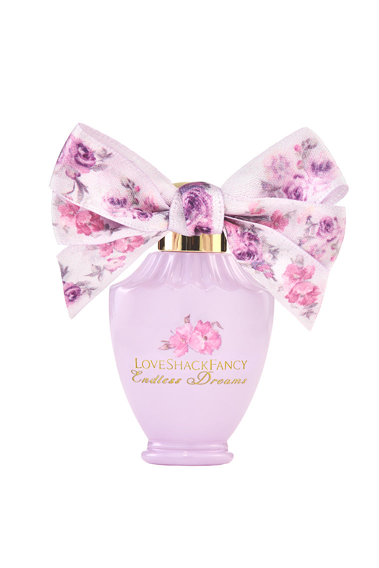 LoveShackFancy mini eau de parfum bottle with floral bow and pink glass