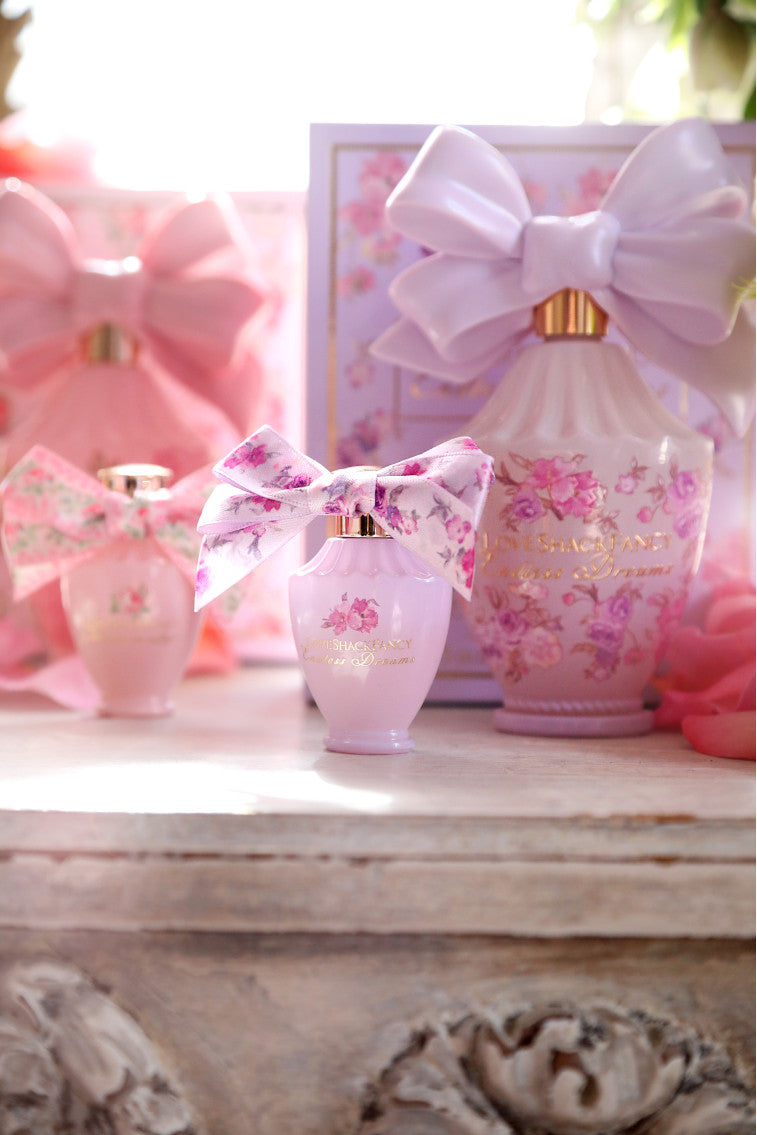LoveShackFancy mini eau de parfum set with ribbon bows and boxed bottles