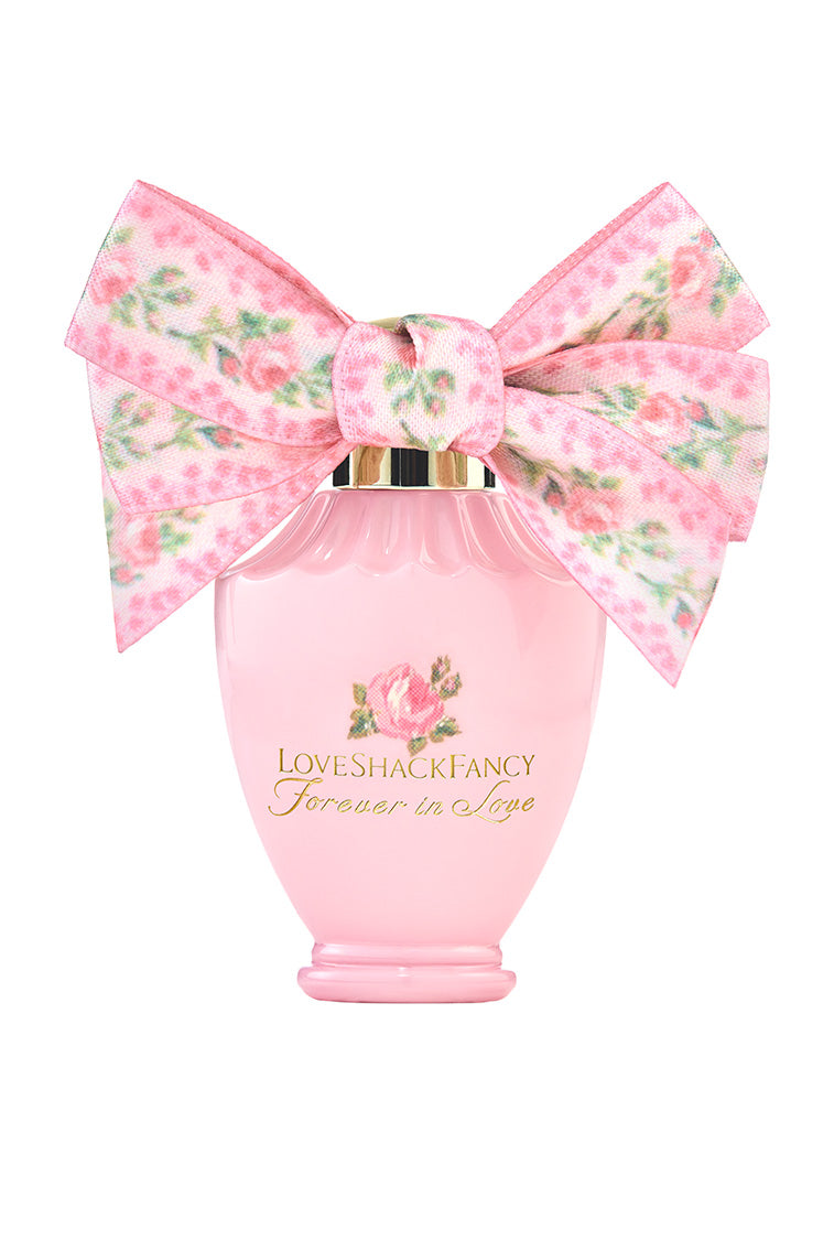 LoveShackFancy mini eau de parfum bottle with large floral bow, pink glass