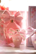 LoveShackFancy mini eau de parfum bottle with ribbon bow and floral gift box