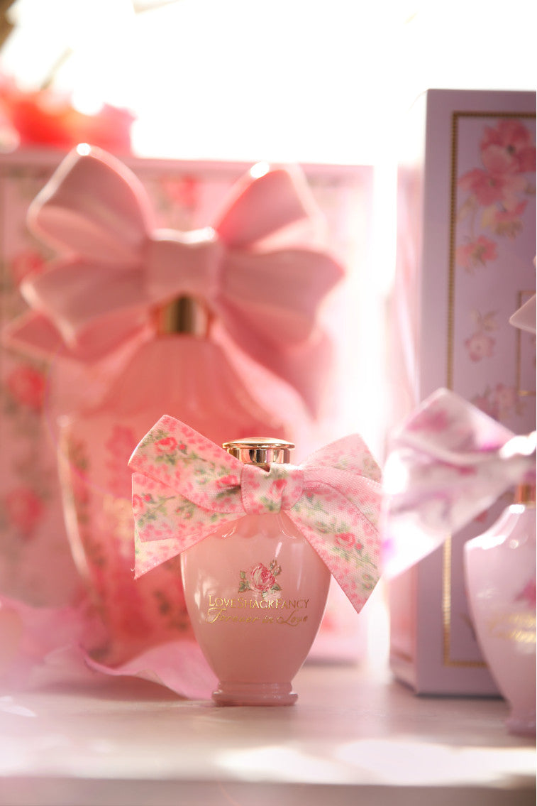 LoveShackFancy mini eau de parfum bottle with ribbon bow and floral gift box