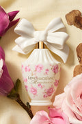 White decorative perfume bottle with white bow and pink floral label
