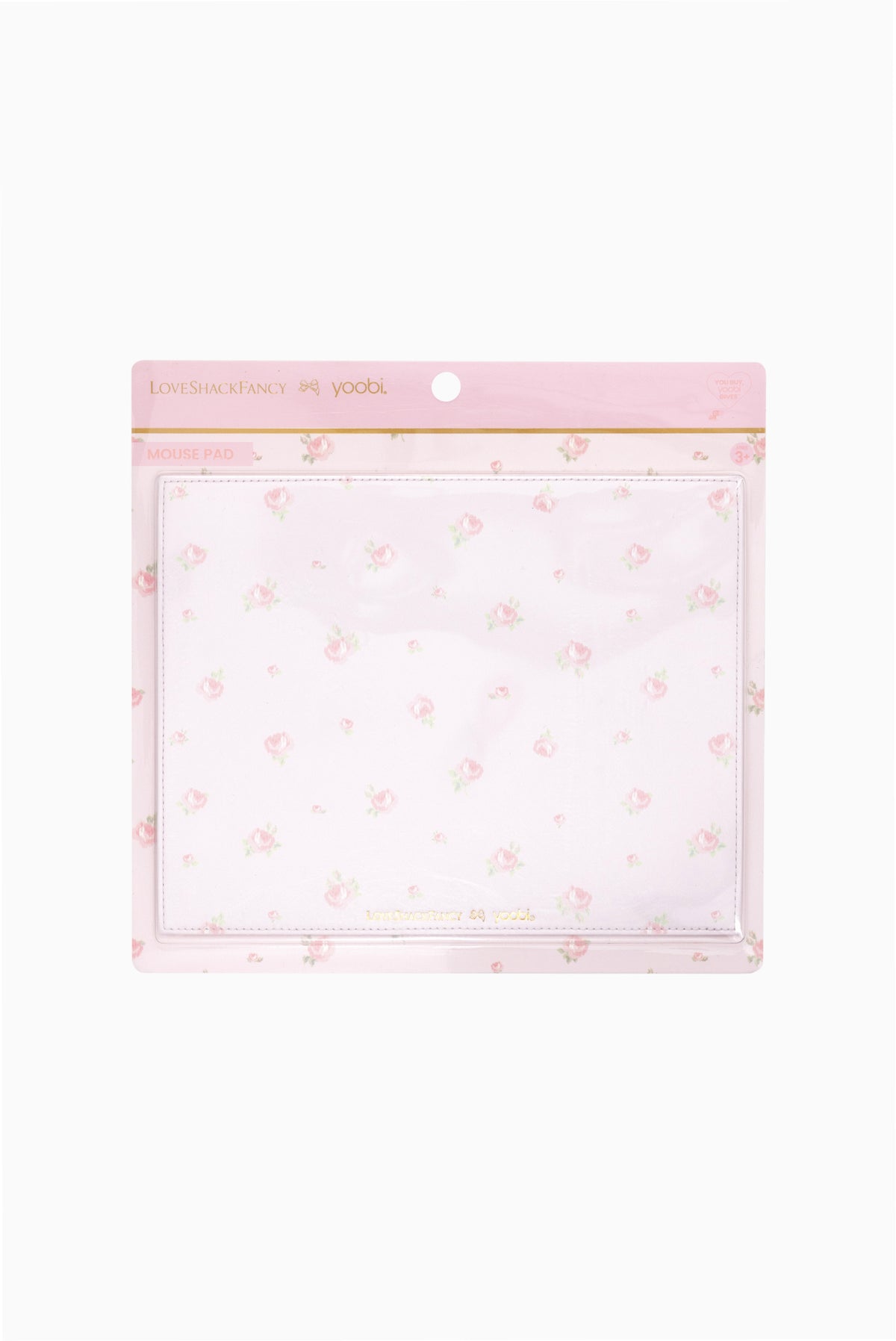 Packaged mouse pad in pink and white ditsy floral design with clear sleeve