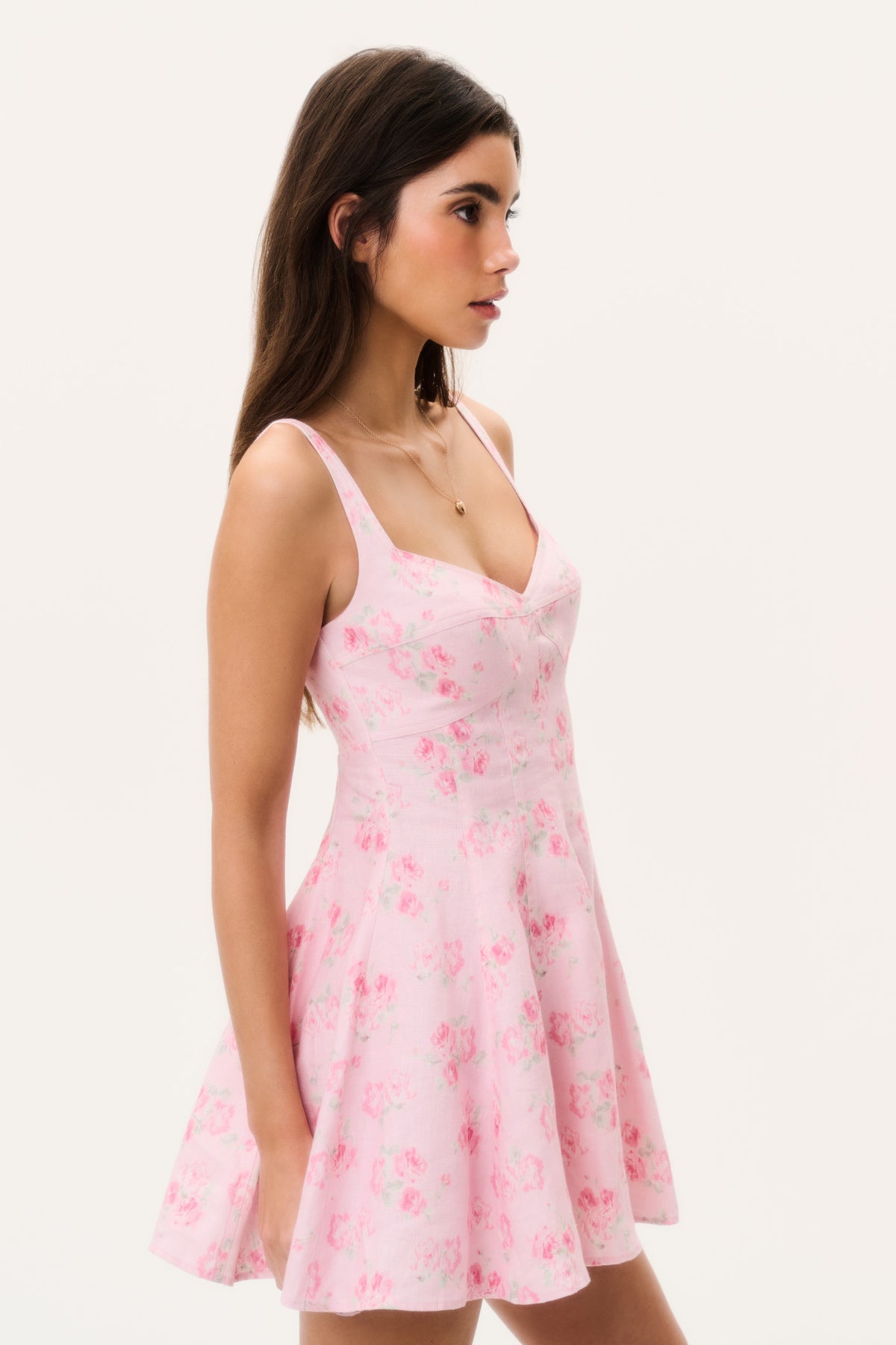 Pink floral linen mini dress with V-neck, thin straps, and flared hemline