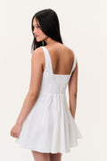 White linen mini dress back view with adjustable straps and gathered waist