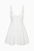 White linen mini dress with square neckline and fitted bodice, flared skirt