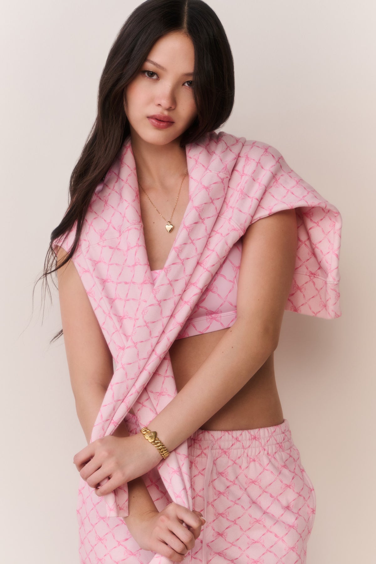 Pink cotton hoodie with hood and drawstring, V-neck slit detail at neckline, short sleeves