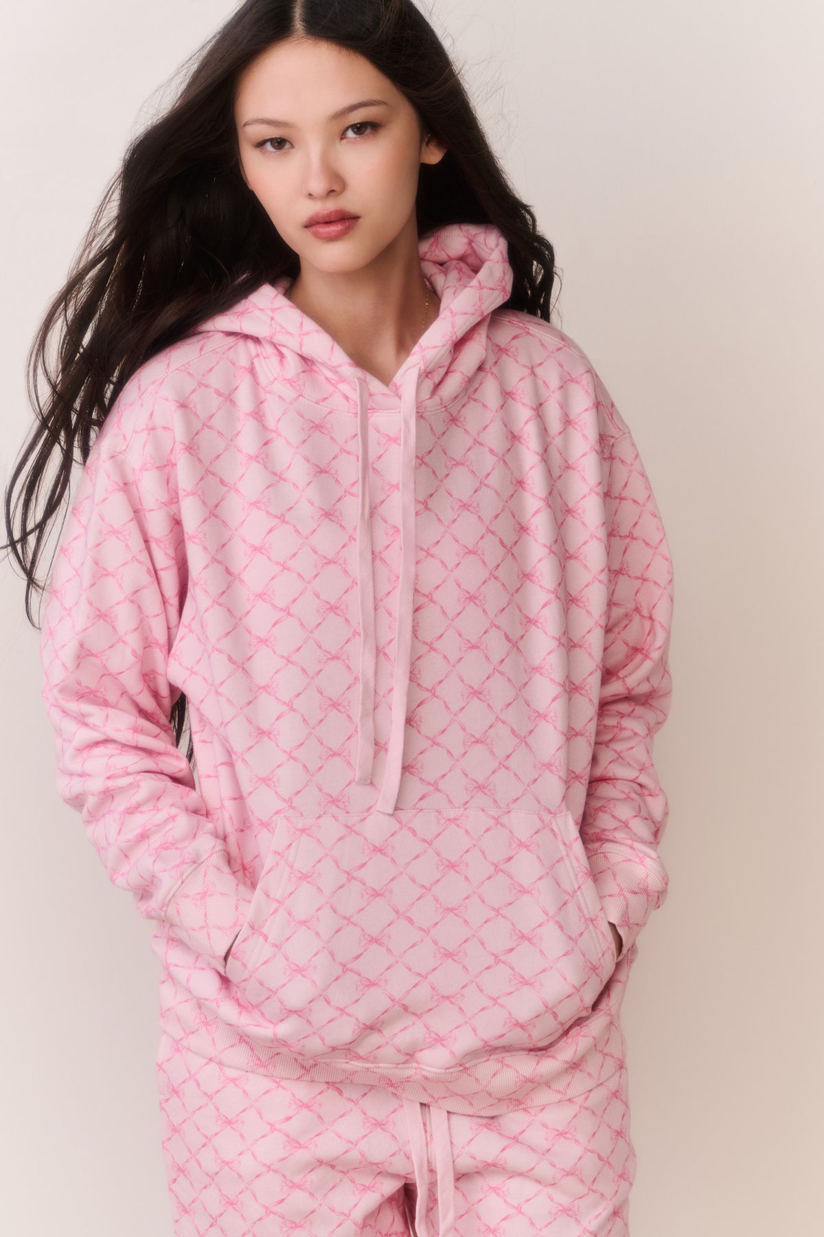 Pink cotton pullover hoodie with hood and drawstring, front view, front kangaroo pocket