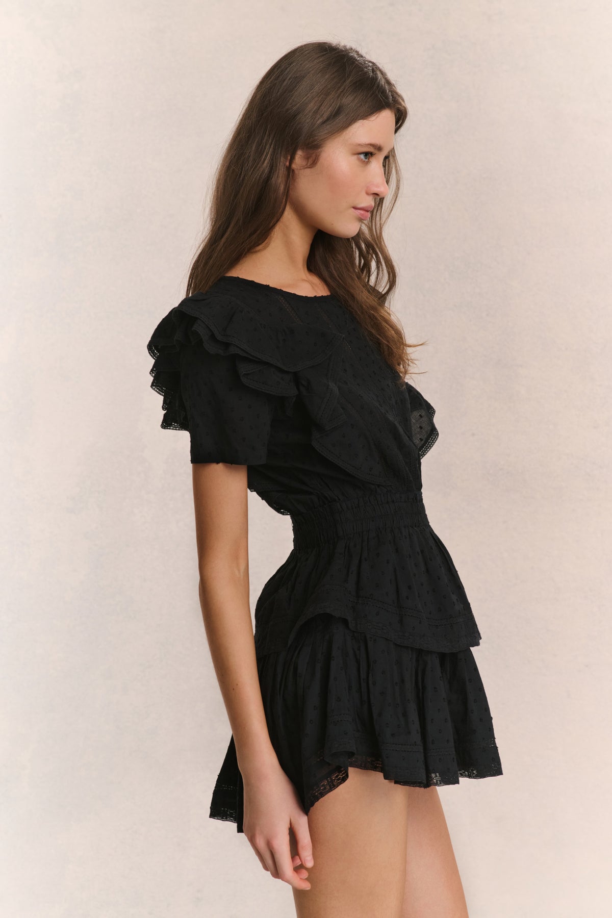 Black mini dress with layered ruffle sleeves and tiered hem