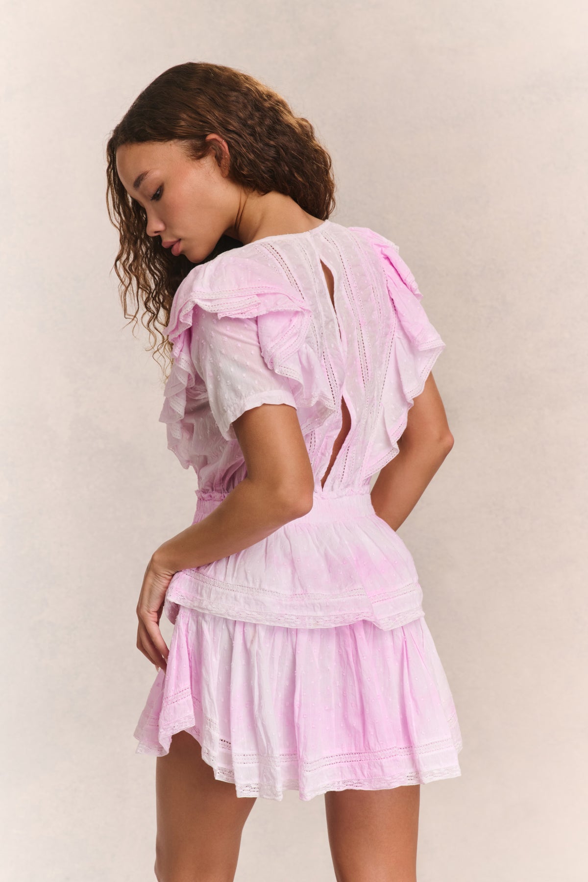 Pink mini dress with back ruffles and layered tiered skirt