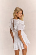 White mini dress back view with ruffle sleeves and open back cutout