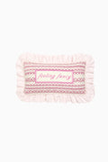 Pink and white decorative needlepoint pillow with ruffled edge and “Feeling fancy”