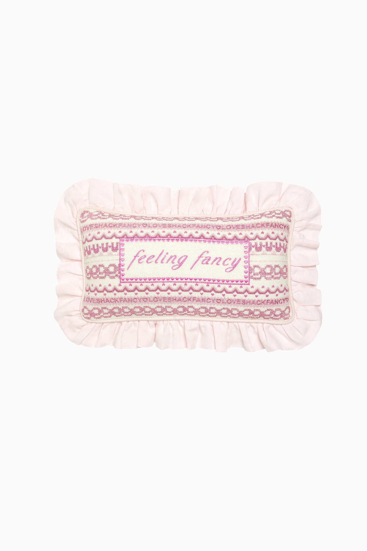 Pink and white decorative needlepoint pillow with ruffled edge and “Feeling fancy”