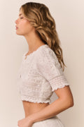 White cotton Victorian crop top, back view with short lace sleeves and button placket