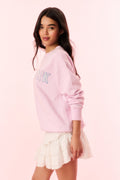 Pink pullover sweatshirt with partial PRK chest print and ribbed cuffs