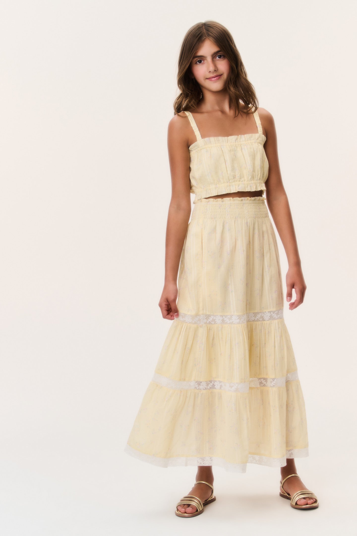 Women sitting in grass field wearing LoveShackFancy Slip Dresses
