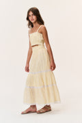 Light yellow tiered tween skirt with lace trim and flowing tiered hem