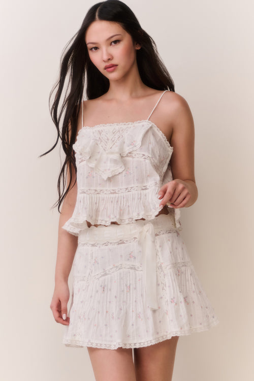 Floral embroidered cotton top with bow-like ruffle accents, spaghetti straps, light cream