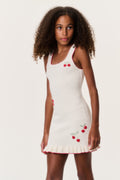 Kids sleeveless cream cherry dress with red trim at scoop neck and ruffle hem