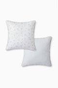 Double-sided outdoor pillow with blue mini motifs and blue-white vertical stripes on reverse