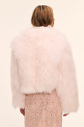 Back view of pale pink fluffy shearling jacket, long sleeves and cropped length