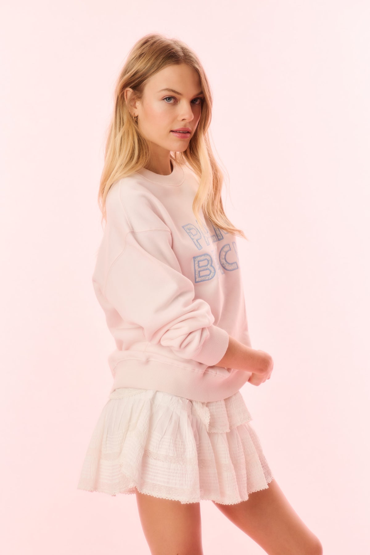 Cream pullover sweatshirt with blue 'BE' graphic on chest (front)