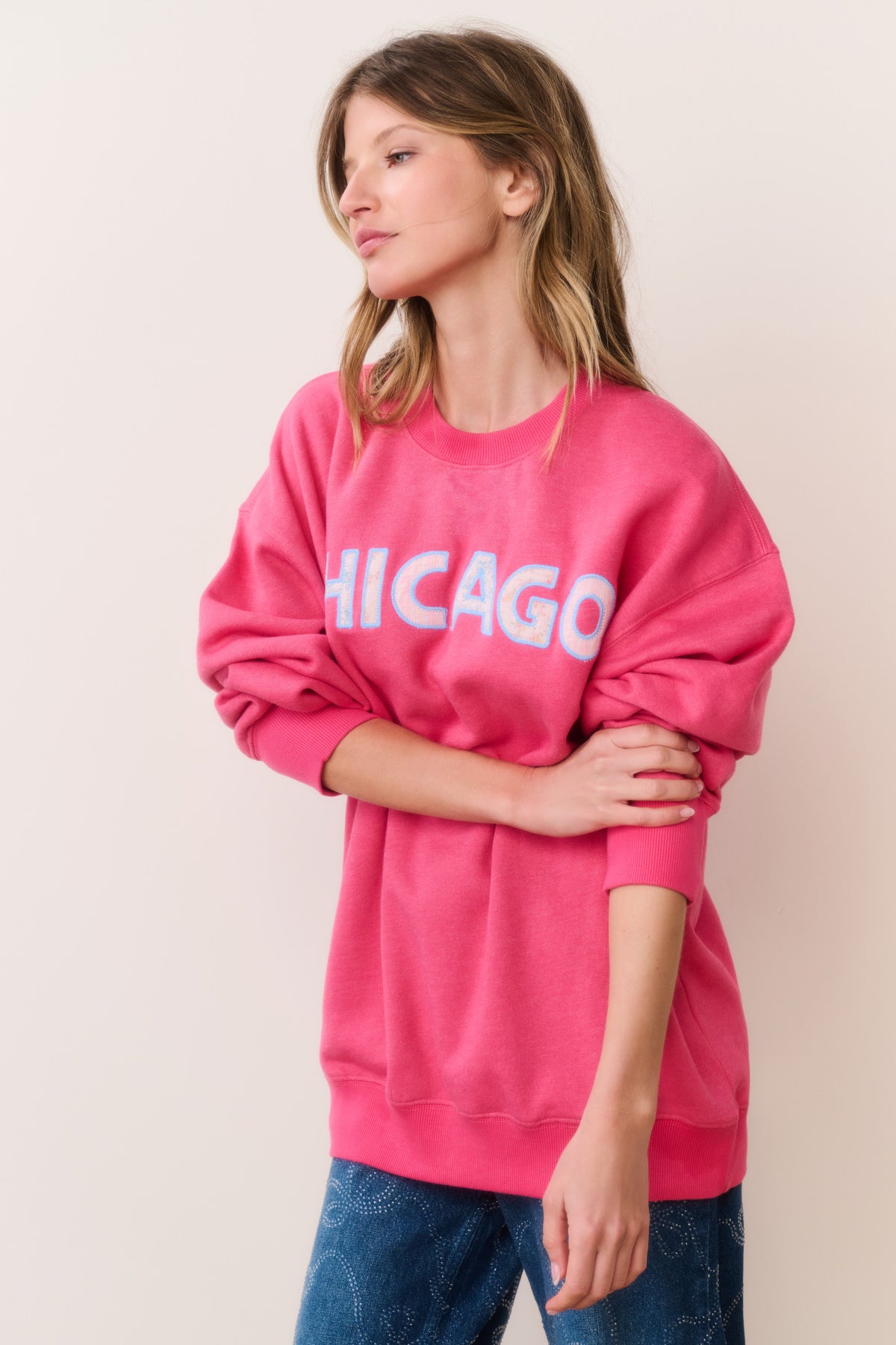 Location pullover sweatshirt in hot pink with CHICAGO graphic, side view