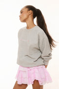 Gray pullover sweatshirt with small chest logo graphic and relaxed fit