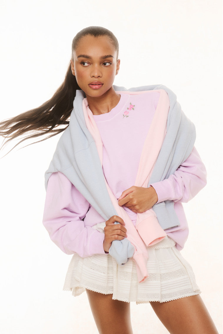 Lavender crewneck pullover with long sleeves and small floral embroidery