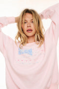 Pink fleece pullover with multicolor stripe graphic across the chest, crew neck