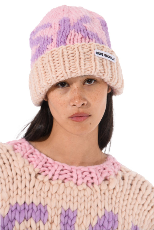 Pink and purple knit ski beanie with cream ribbed brim and small logo label