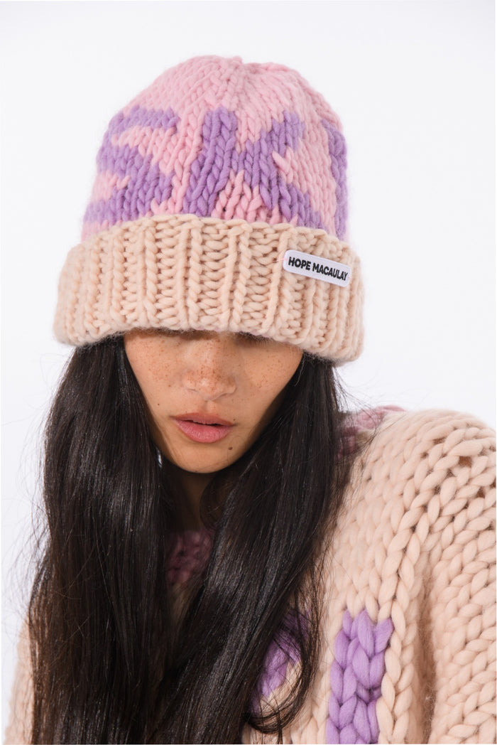 Knit ski beanie with pink and purple stripes and cream ribbed cuff, logo patch