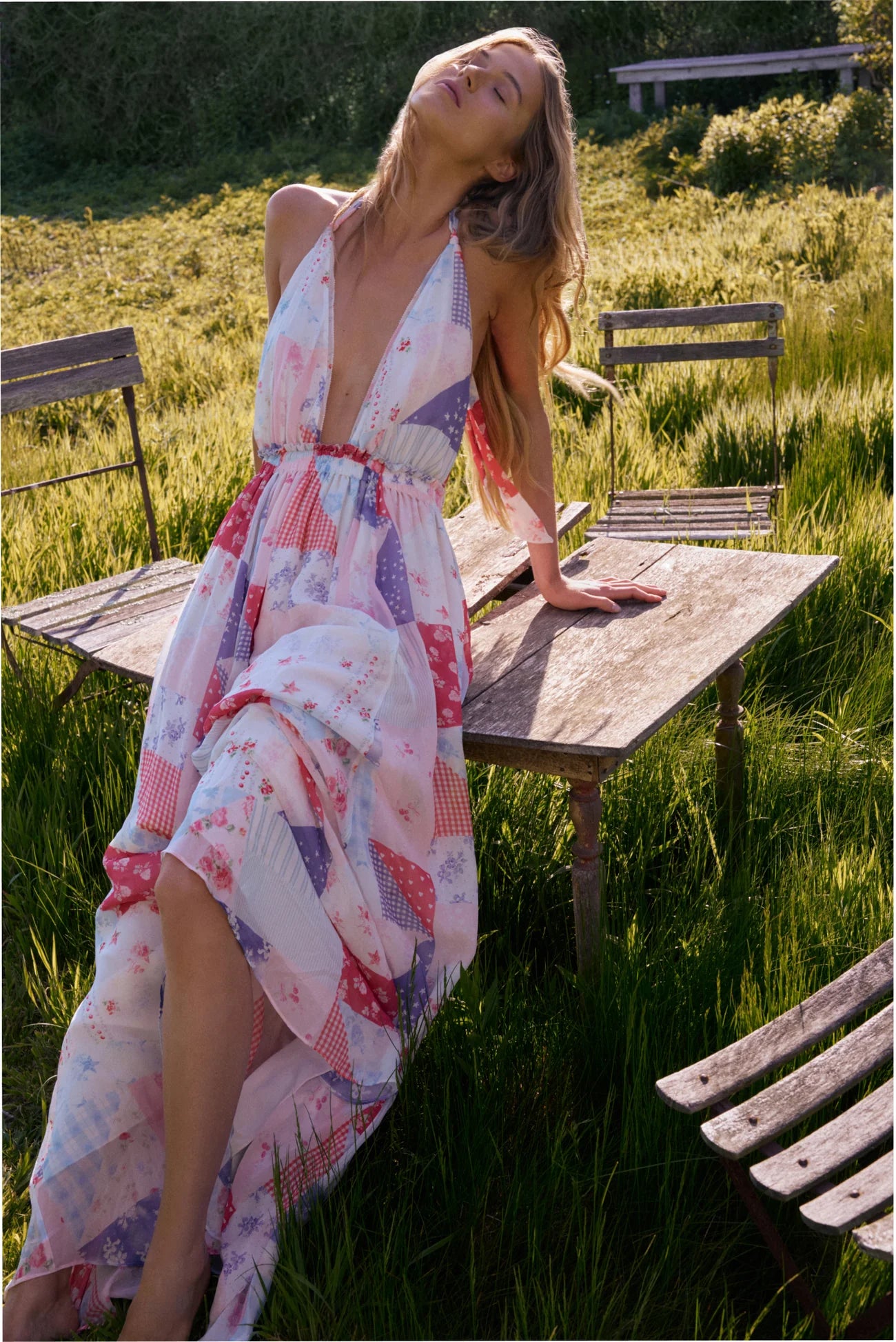 Women sitting in grass field wearing LoveShackFancy Slip Dresses