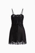 Black lace-detailed mini slip dress with spaghetti straps and bow-tied waist