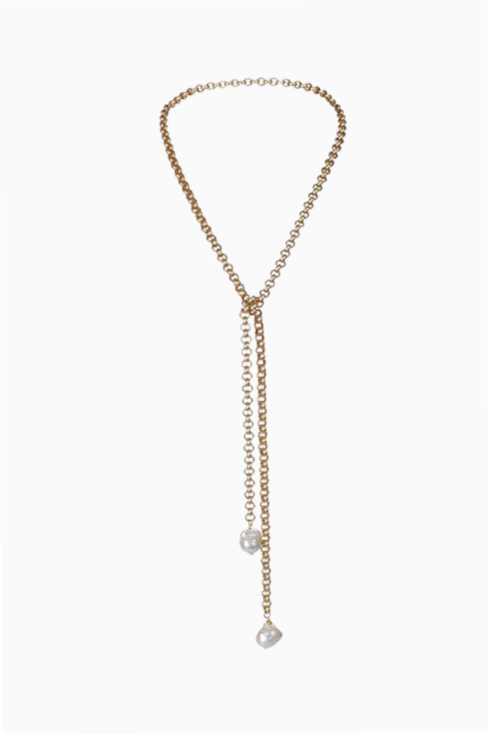 Gold lariat necklace with two wild pearls and a small dangling charm