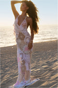 Pale pink crochet maxi dress in patchwork lace with V-neck and thin spaghetti straps.