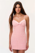 Pink tweed mini dress with spaghetti straps and front bow neckline