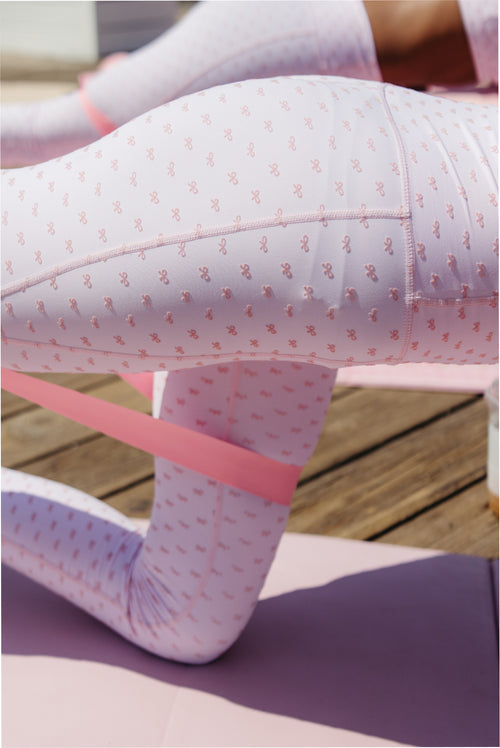 Close-up of mauve patterned leggings with elastic waistband and stitched seams