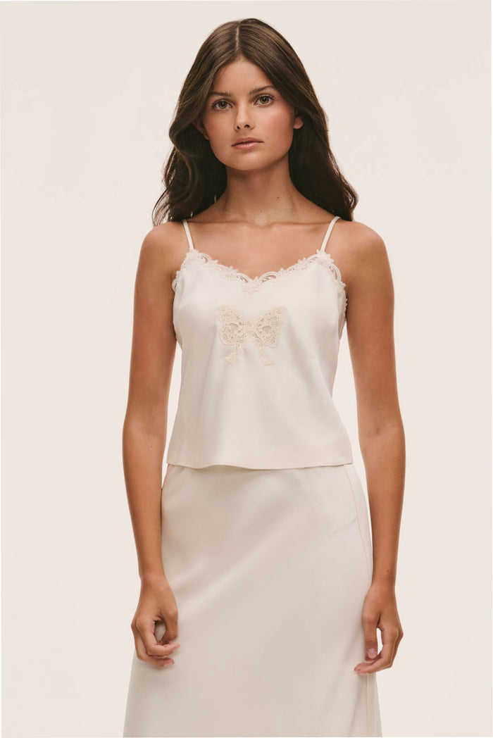 Light cream cami with scalloped lace neckline, embroidered trim, and spaghetti straps