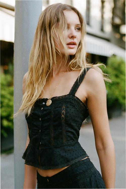 Black lace camisole top with thin straps and gold-tone button placket