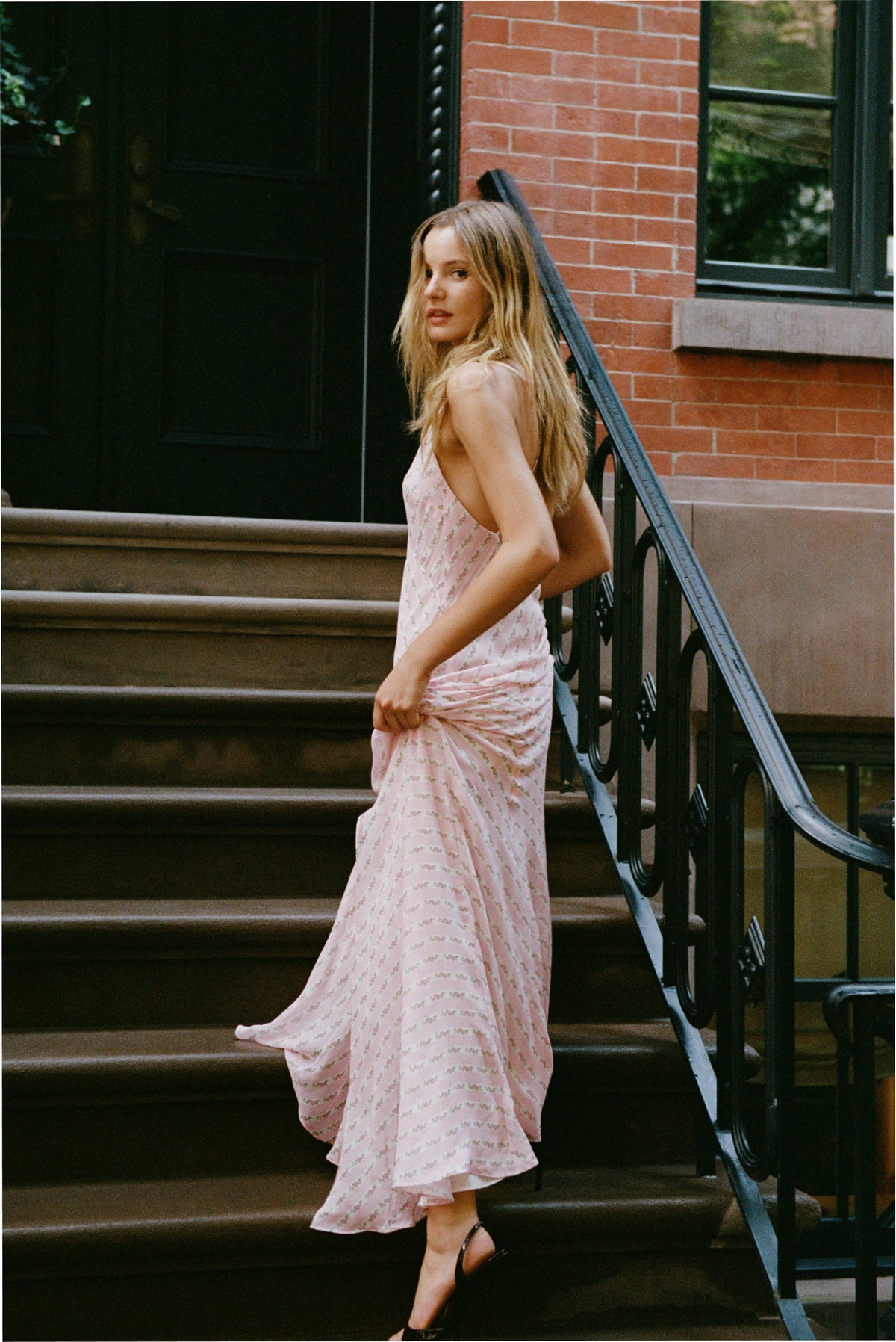 Light pink maxi dress side view with spaghetti straps, V-neck, and flowing drape.