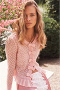 Light pink pointelle cardigan with bow-front trim and ruffle peplum hem, long sleeves