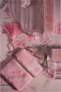 Pastel pink mahjong tile set with decorative motifs and matching accessories