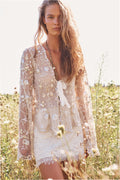 Off-white lace mini skirt with scalloped lace hem and allover floral detailing