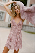 Pink snakeskin-print mini dress with spaghetti straps and ruffled hem, model wearing