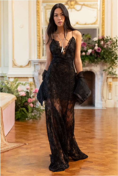 Black lace maxi dress with V neckline, thin straps, long sheer overlay skirt