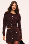 Burgundy cable-knit cardigan with button front and long sleeves