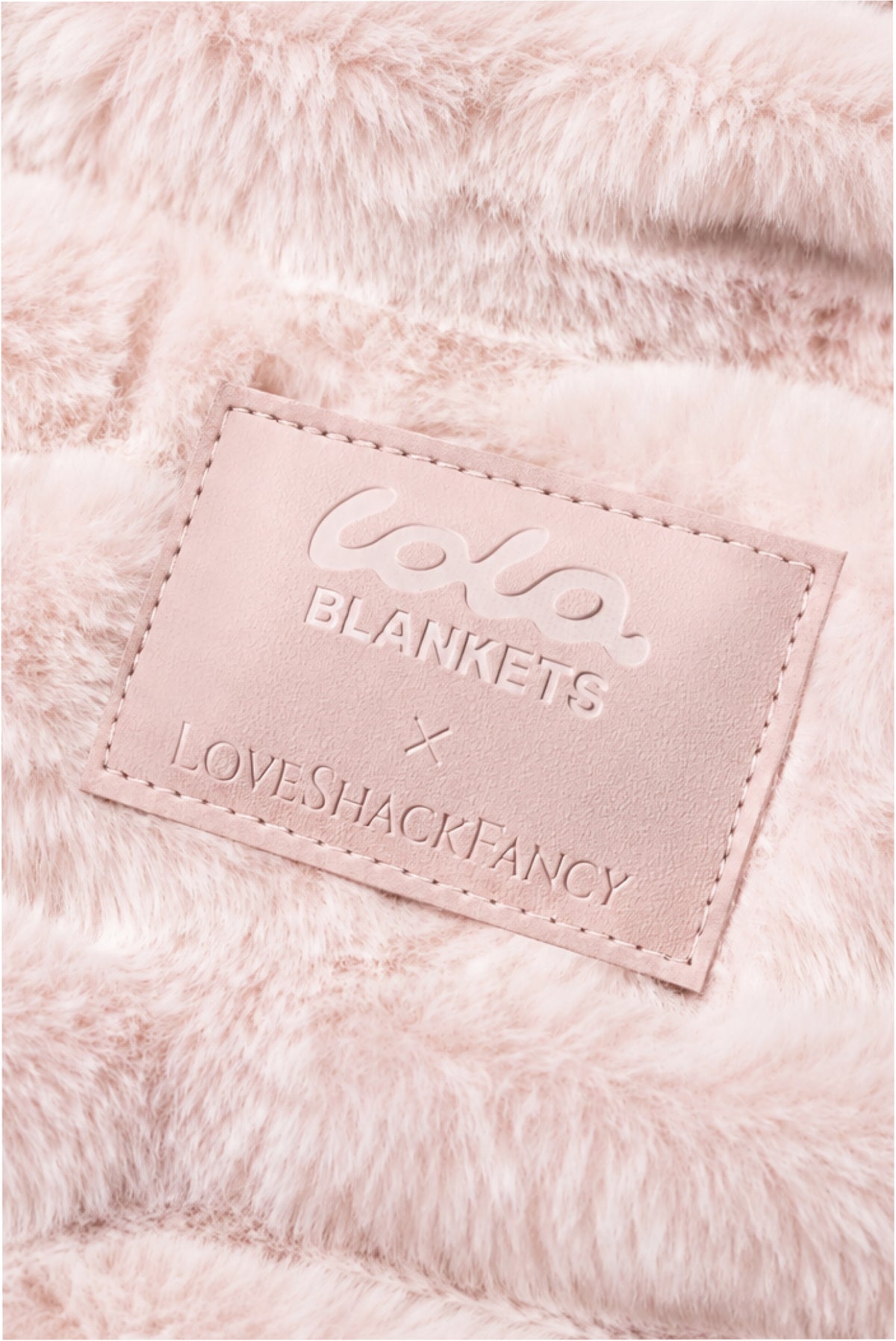 Close-up of throw blanket in petal pink textured with a soft, frosted finish