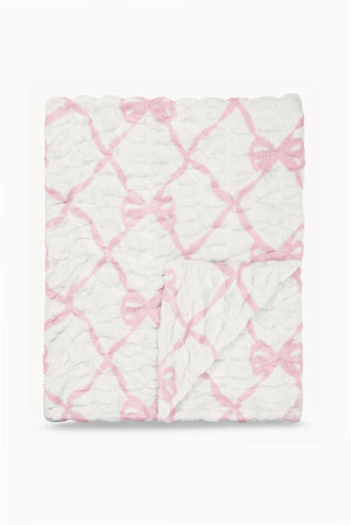 Folded fleece-style blanket with pink bow lattice pattern on white background
